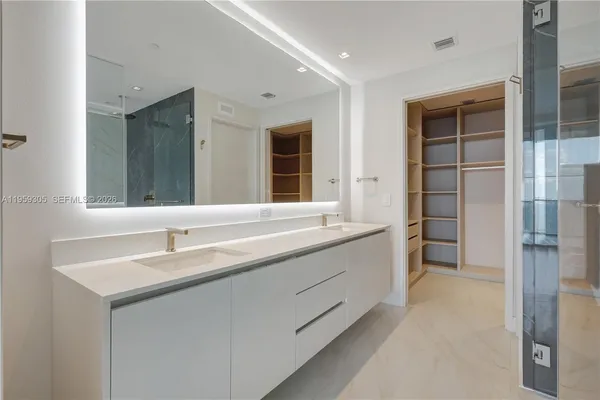 a view of walk in closet with empty racks