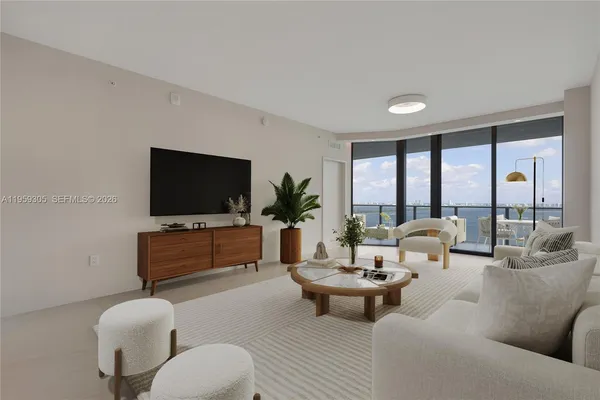 a kitchen with stainless steel appliances a stove a sink a oven a dining table and chairs with wooden floor