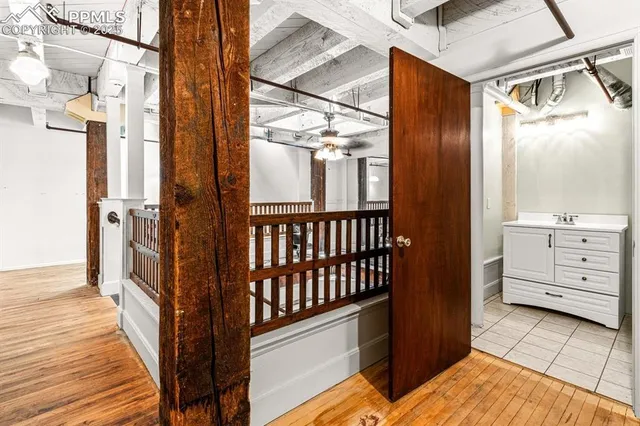 a view of a hallway with wooden floor