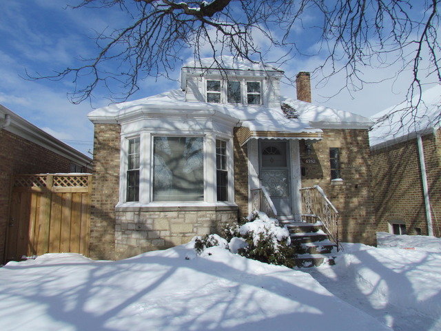 6952 West Foster Avenue Chicago, IL 60656 - Photo 1 of 14 a front view of a house with a yard