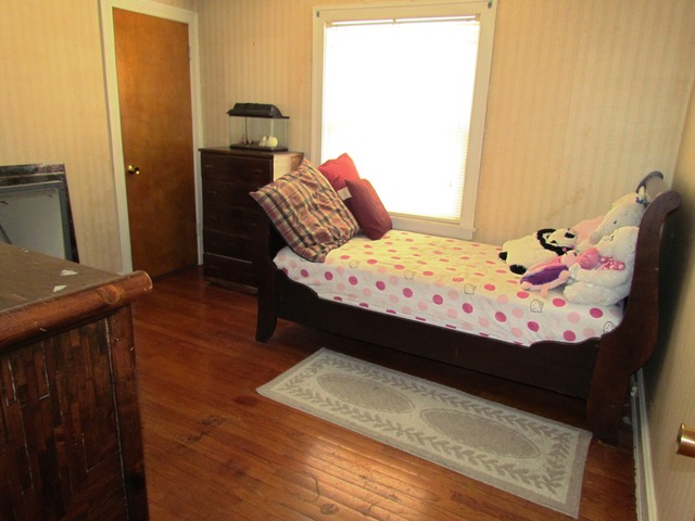 6952 West Foster Avenue Chicago, IL 60656 - Photo 11 of 14 a bed sitting in a bedroom next to a window with storage