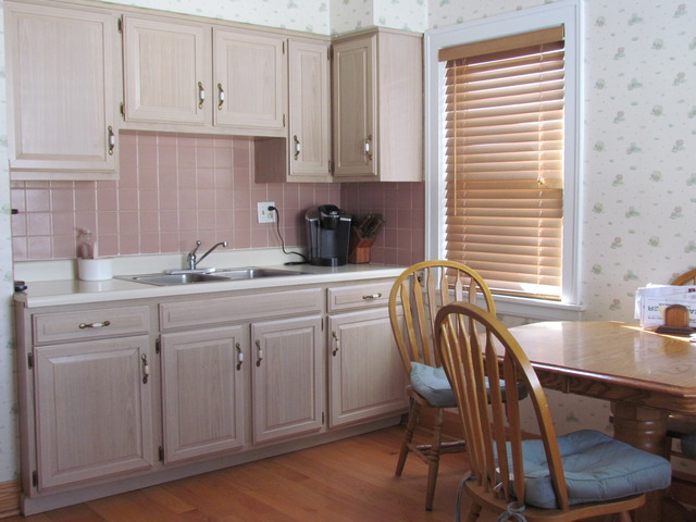 6952 West Foster Avenue Chicago, IL 60656 - Photo 3 of 14 a kitchen with stainless steel appliances granite countertop a sink a stove a dining table and chairs