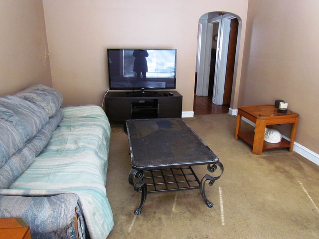 6952 West Foster Avenue Chicago, IL 60656 - Photo 8 of 14 a living room with furniture and a flat screen tv