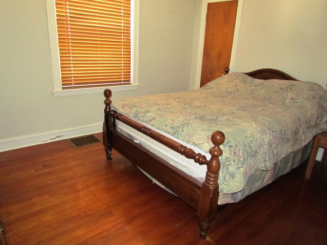 6952 West Foster Avenue Chicago, IL 60656 - Photo 10 of 14 a view of a bedroom with a bed and wooden floor