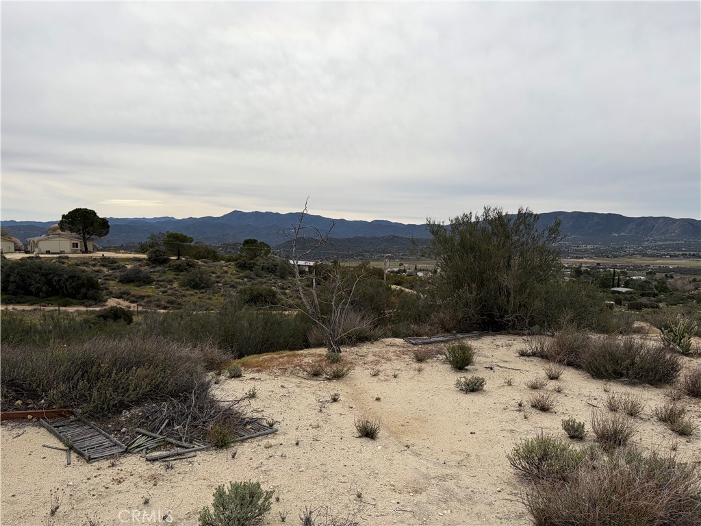 61200 Indian Paint Brush Road Anza, CA 92539 - Photo 66 of 73 a view of white house with a yard covered with snow in the background