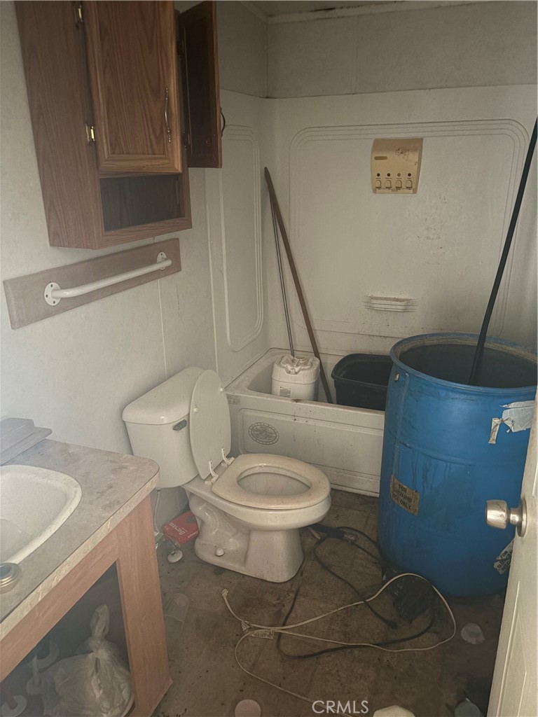 61200 Indian Paint Brush Road Anza, CA 92539 - Photo 9 of 73 a white toilet sitting next to a bathroom sink and tub