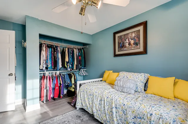 a bedroom with a bed and a large mirror