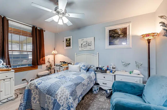 a bedroom with a bed couch and window