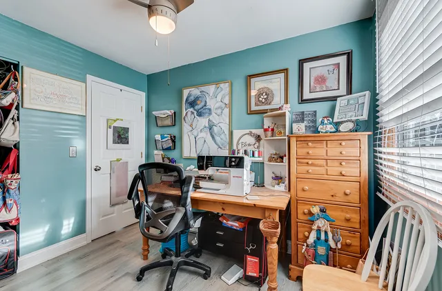a work room with furniture and wooden floor