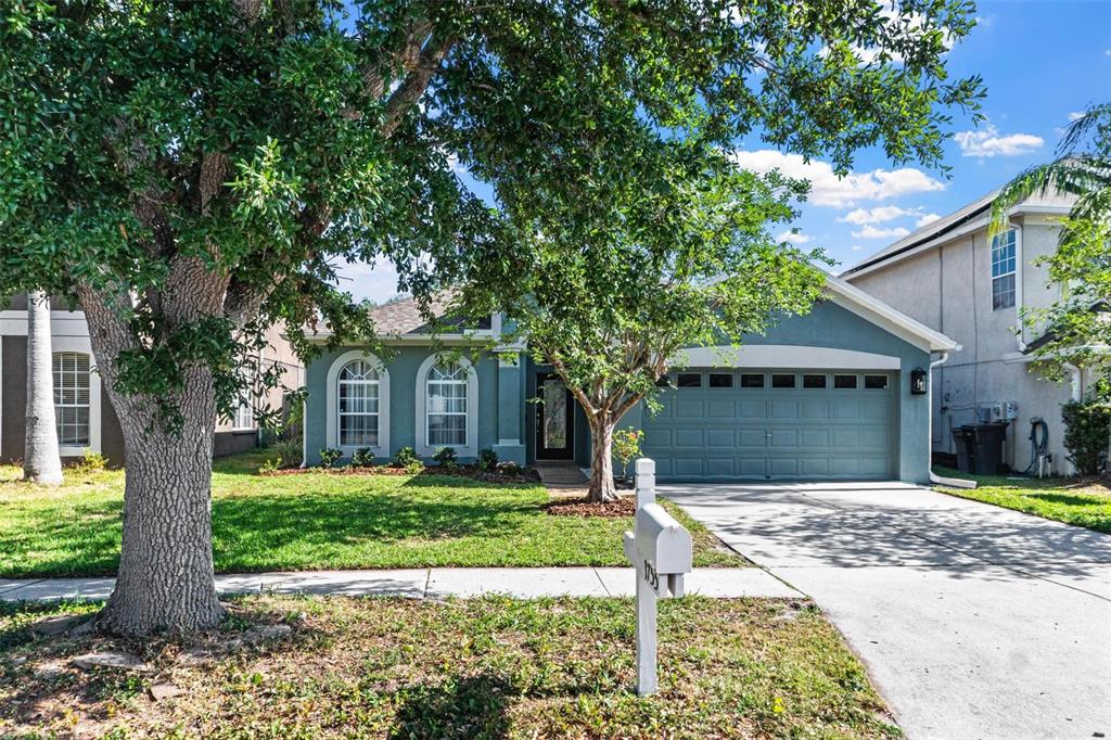 1755 Open Field Loop Brandon, FL 33510 - Photo 1 of 1 a front view of a house with a yard and potted plants