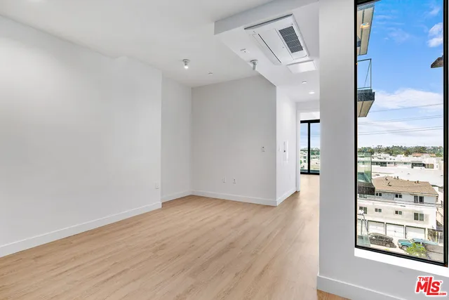 a view of a room with wooden floor