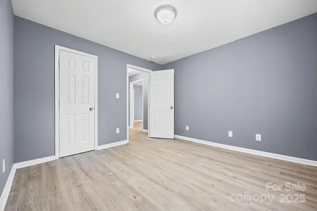 a view of an empty room and wooden floor