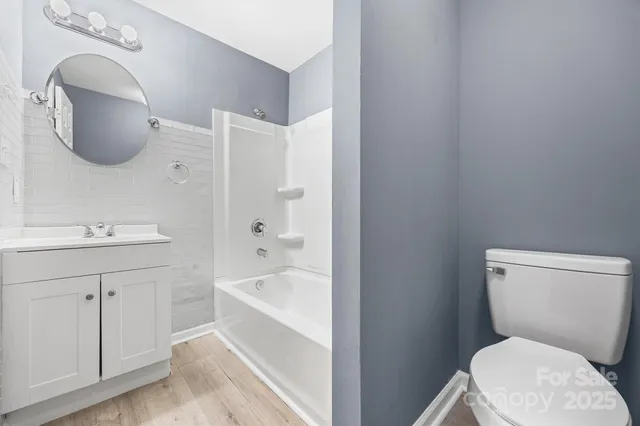 a white toilet sitting next to a bathroom sink