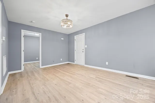a view of an empty room and wooden floor