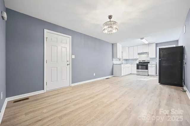 a view of a kitchen with a sink and refrigerator