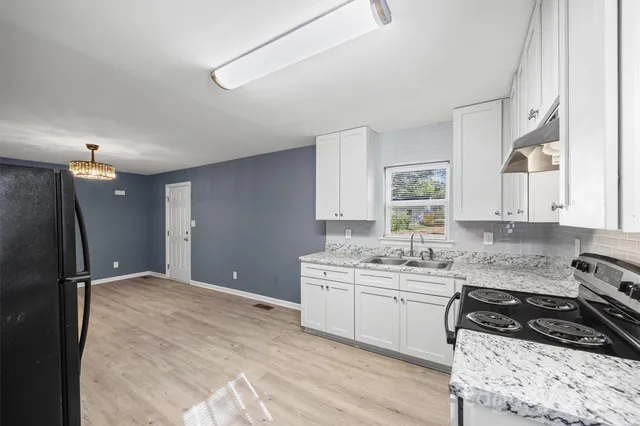 a kitchen with a sink stove and refrigerator