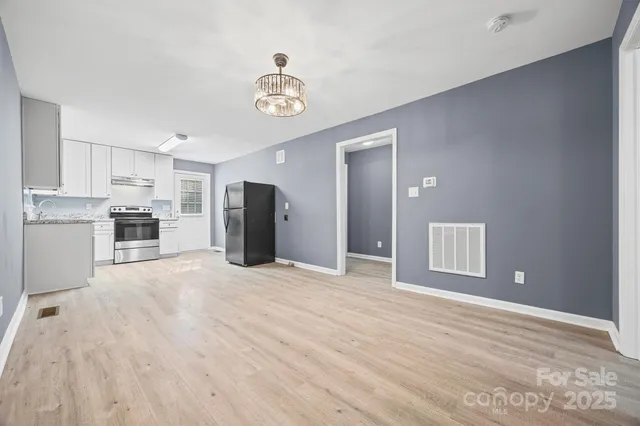 a view of a kitchen with a sink and a refrigerator