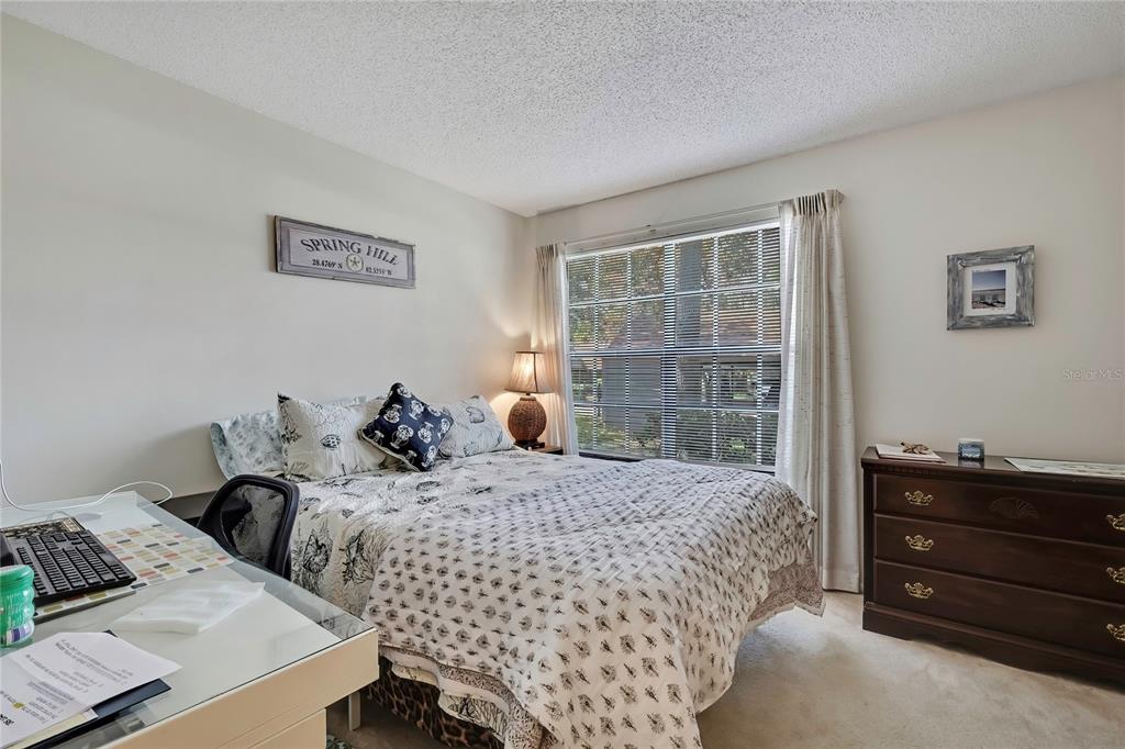 2111 Forester Way Spring Hill, FL 34606 - Photo 13 of 33 a bedroom with bed and wooden floor