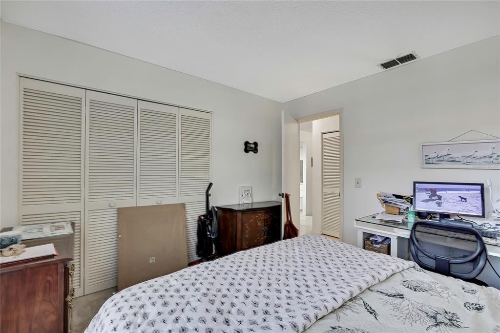 2111 Forester Way Spring Hill, FL 34606 - Photo 15 of 33 a bedroom with a bed and a desk