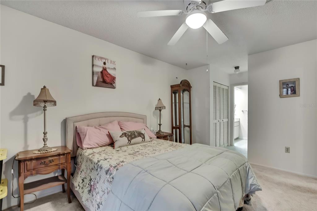 2111 Forester Way Spring Hill, FL 34606 - Photo 18 of 33 a bedroom with a bed and a chandelier