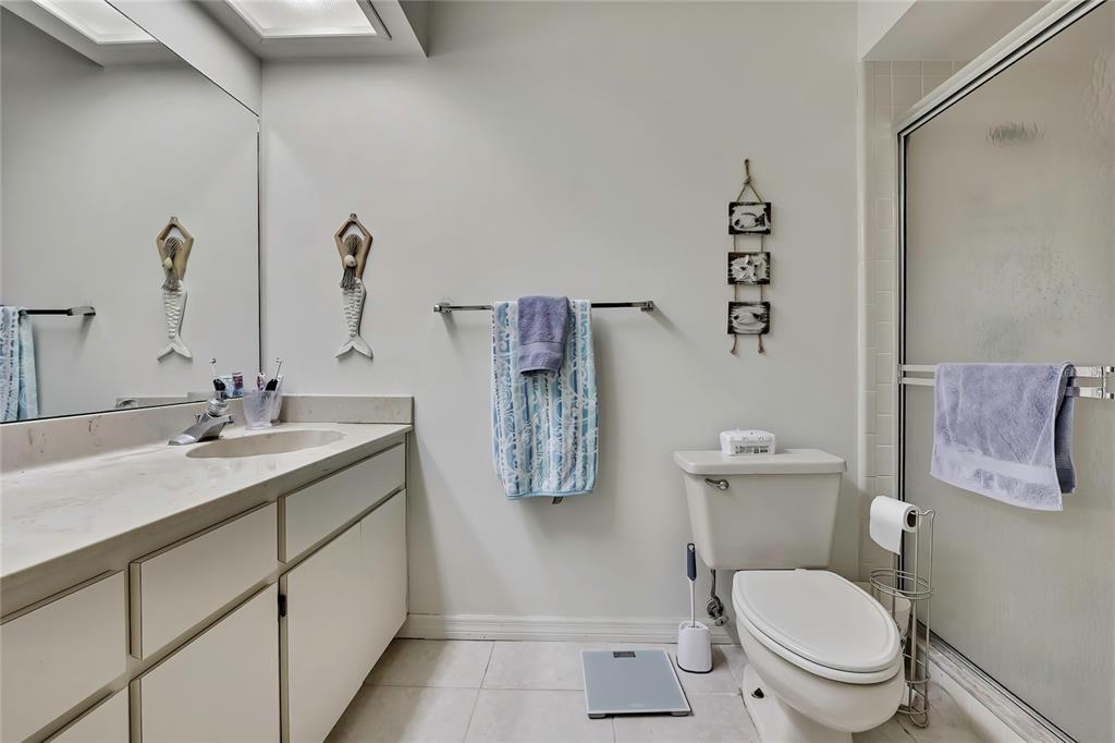 2111 Forester Way Spring Hill, FL 34606 - Photo 21 of 33 a bathroom with a granite countertop toilet sink and mirror