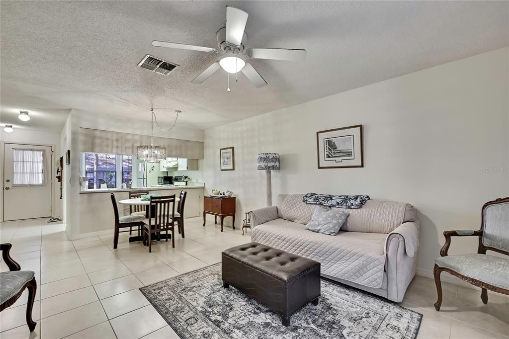 2111 Forester Way Spring Hill, FL 34606 - Photo 5 of 33 a living room with furniture a table and kitchen view
