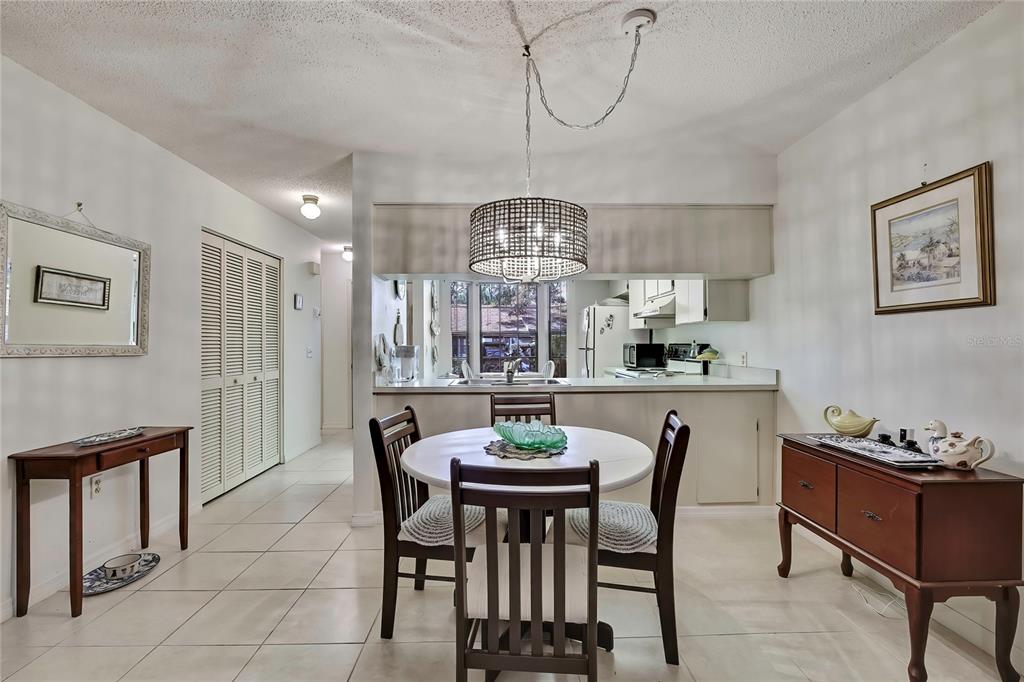 2111 Forester Way Spring Hill, FL 34606 - Photo 7 of 33 a view of a dining room with furniture a chandelier and wooden floor