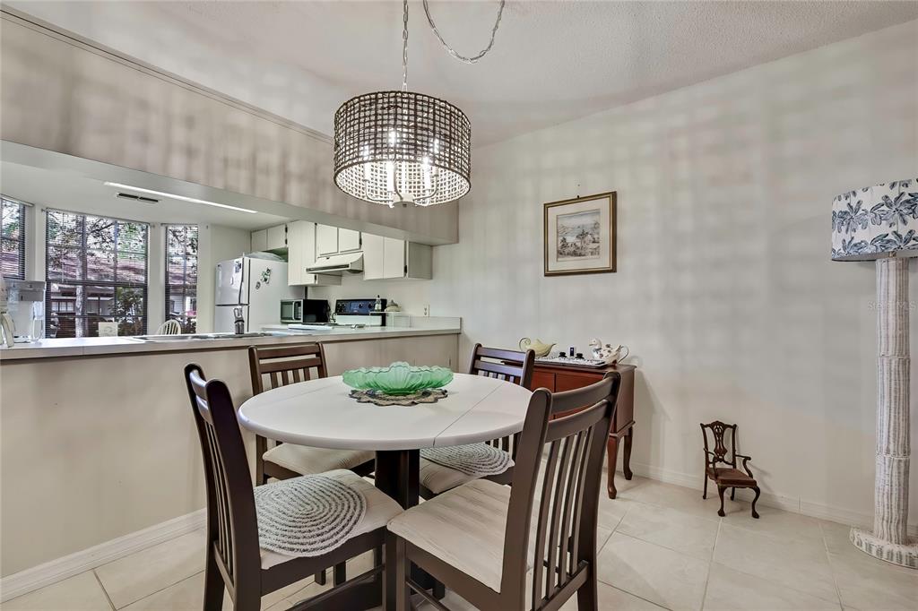 2111 Forester Way Spring Hill, FL 34606 - Photo 8 of 33 a view of a dining room with furniture a chandelier and wooden floor