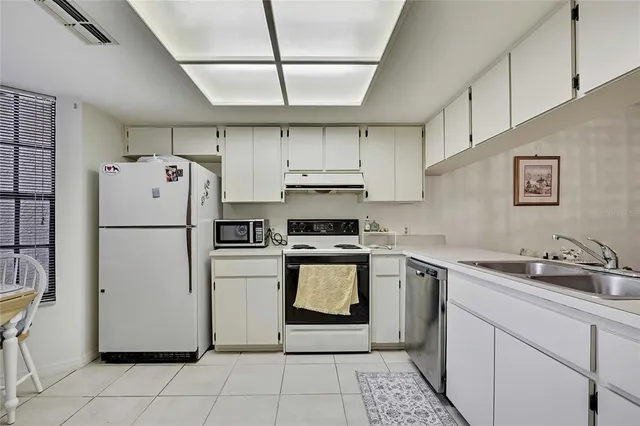 a kitchen with a stove sink and refrigerator