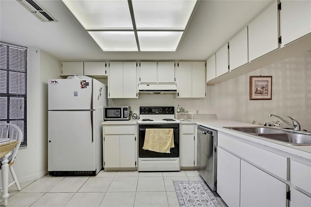 2111 Forester Way Spring Hill, FL 34606 - Photo 9 of 33 a kitchen with a stove sink and refrigerator