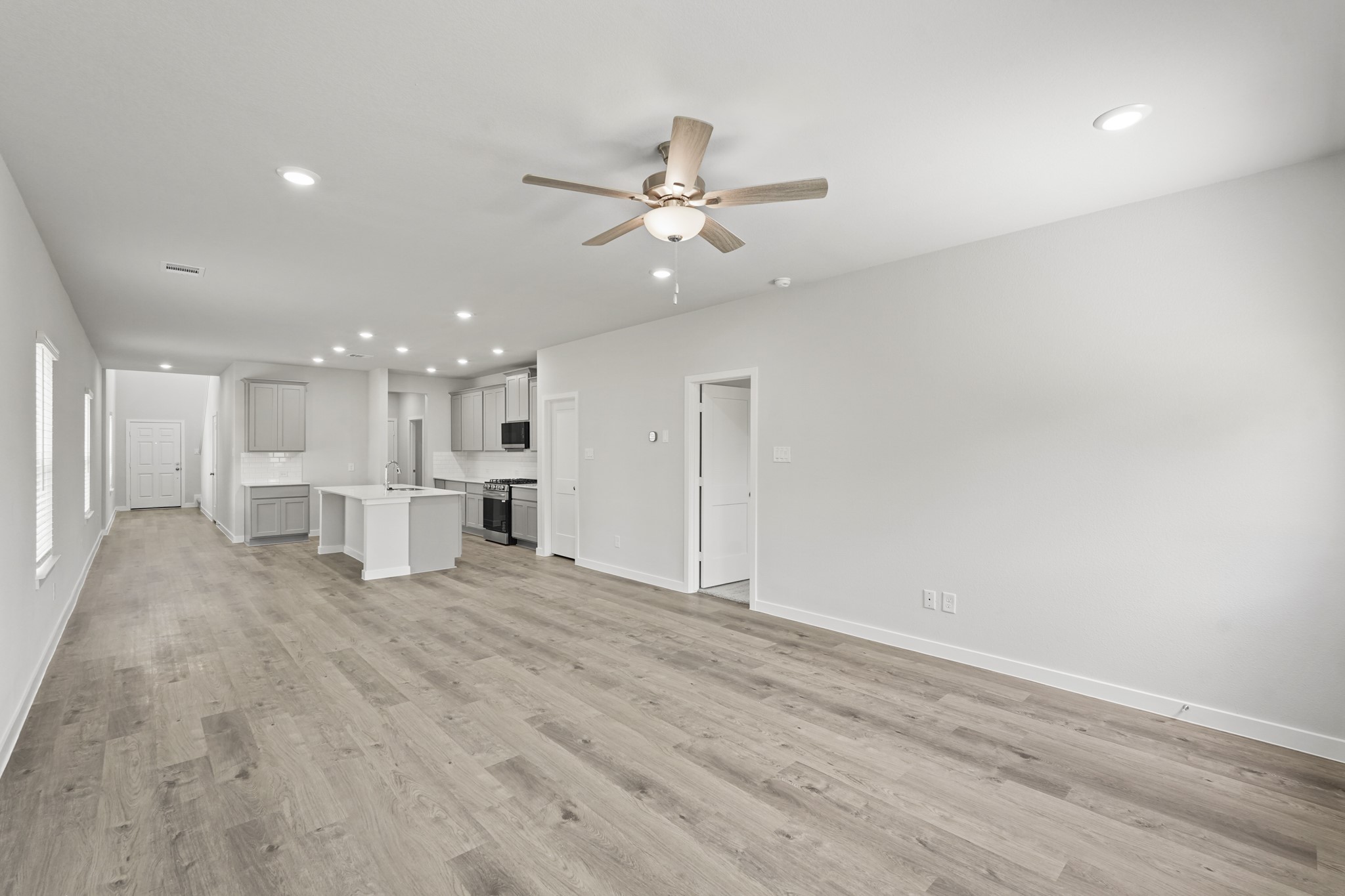 213 Spring Drive Hockley, TX 77447 - Photo 12 of 26 a view of an empty room with a ceiling fan