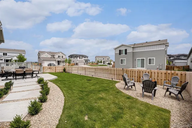 a view of a house with a patio and a yard