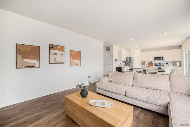 a living room with furniture and wooden floor