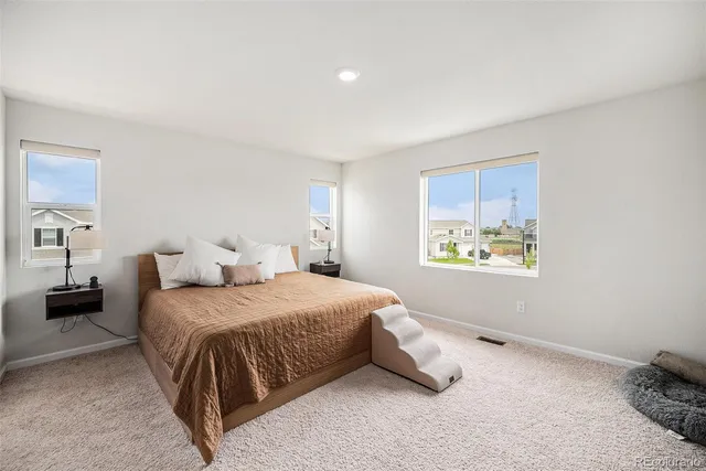 a bedroom with a bed and a painting on the wall
