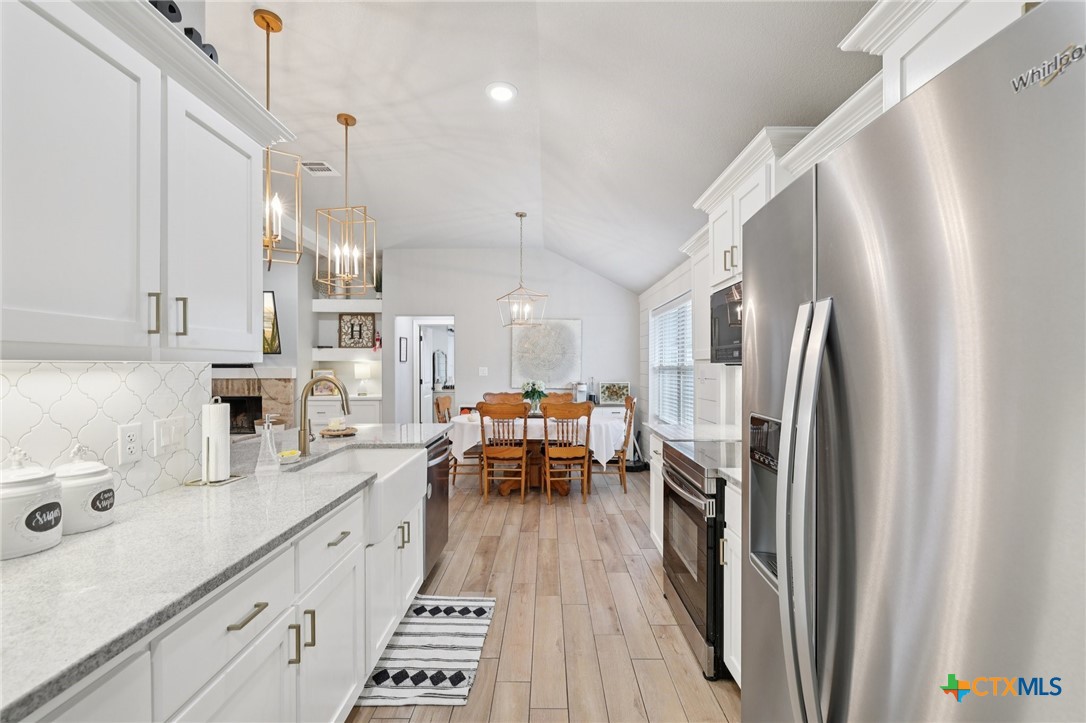 1522 Curlew Lane Temple, TX 76502 - Photo 11 of 35 a kitchen with stainless steel appliances a refrigerator a sink a stove and white cabinets