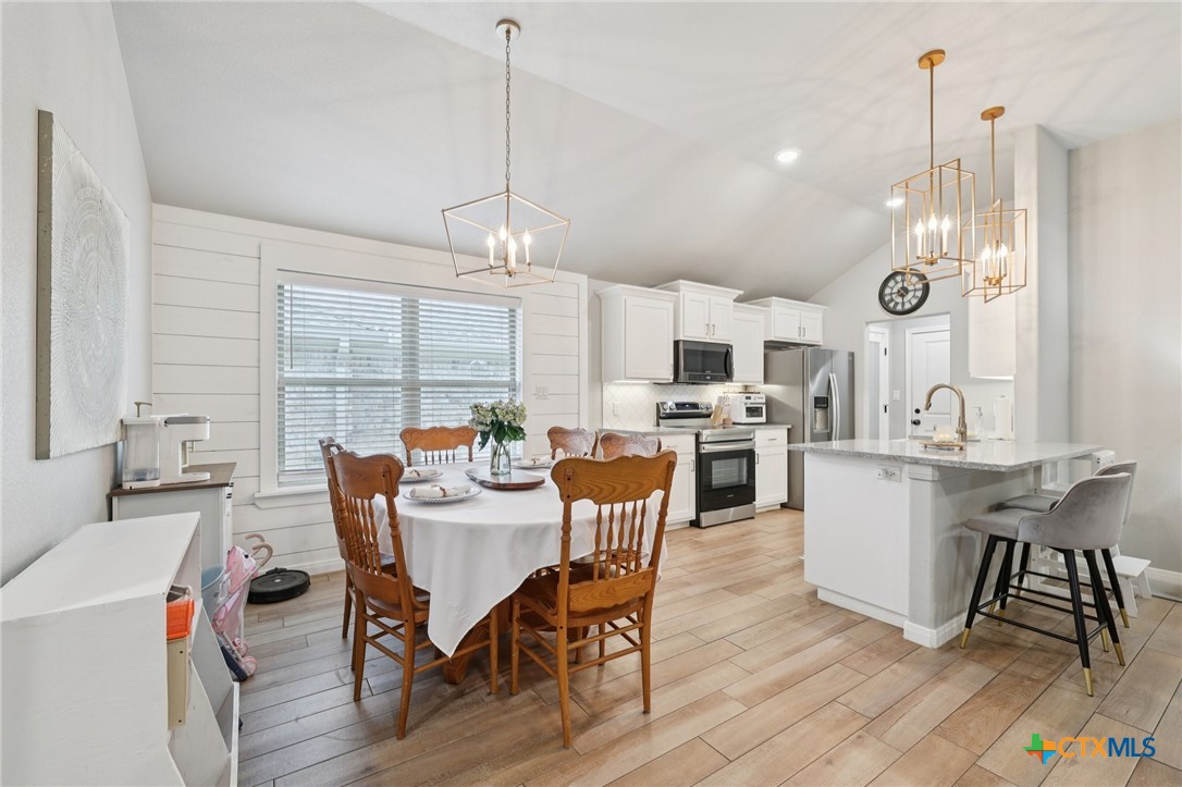 1522 Curlew Lane Temple, TX 76502 - Photo 15 of 35 a view of a dining room and livingroom with furniture wooden floor a chandelier
