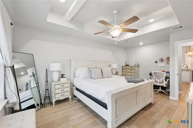 a bedroom with a bed and a chandelier