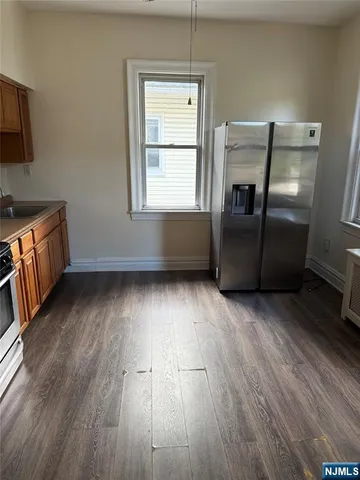 a room with wooden floor and furniture