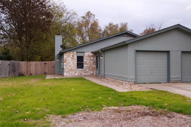 a backyard of a house with yard and trampoline