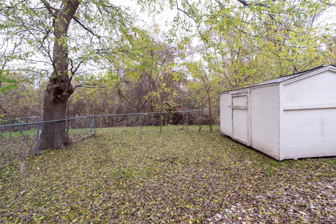 12609 Turtle Rock Road, Unit B Austin, TX 78729 - Photo 24 of 25 a backyard of a house with lots of green space