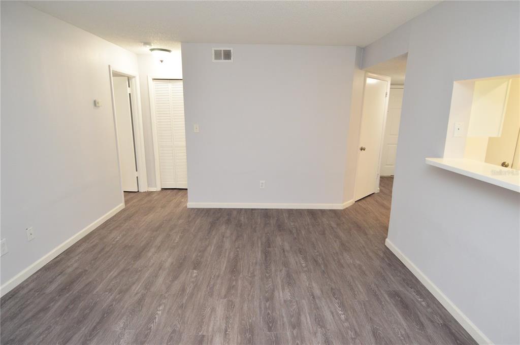 8641 Fancy Finch Drive, Unit 103 Tampa, FL 33614 - Photo 20 of 92 an empty room with wooden floor and a window