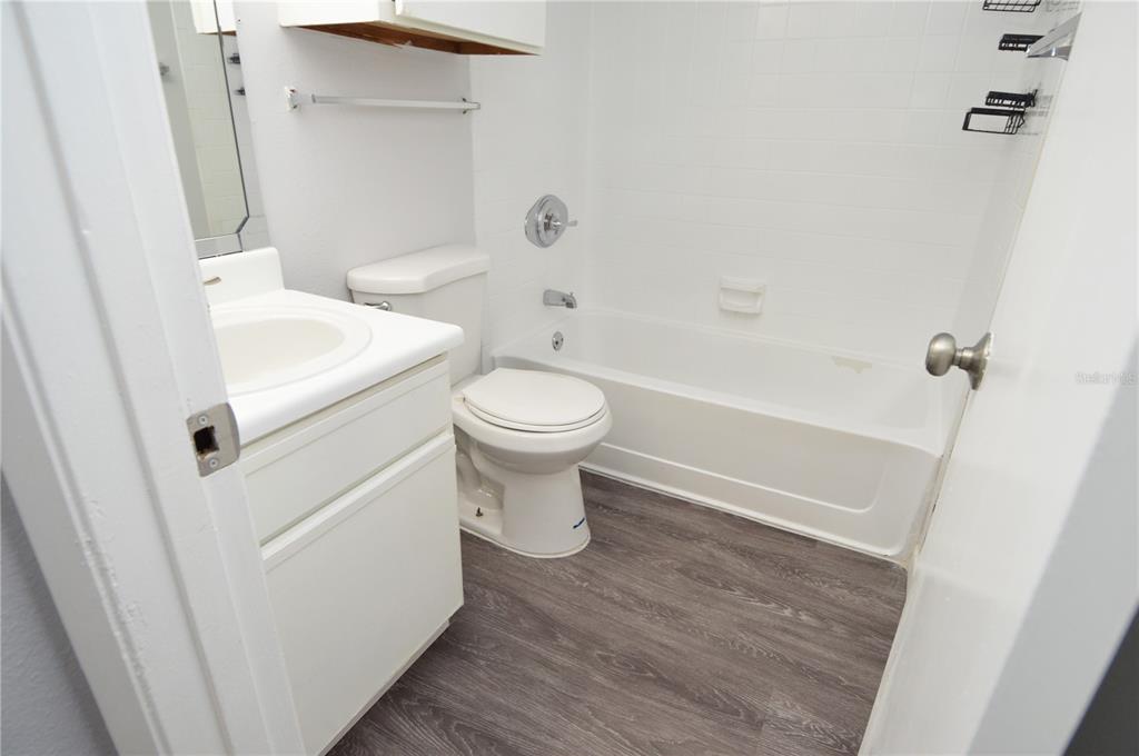 8641 Fancy Finch Drive, Unit 103 Tampa, FL 33614 - Photo 22 of 92 a bathroom with a sink a toilet and shower