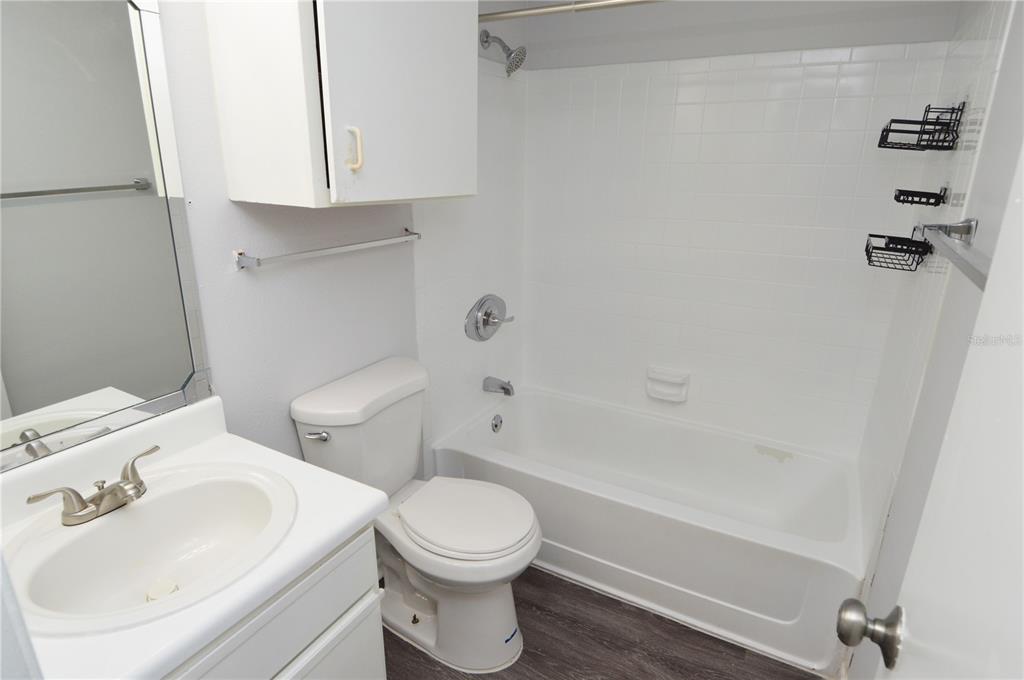 8641 Fancy Finch Drive, Unit 103 Tampa, FL 33614 - Photo 23 of 92 a bathroom with a sink a toilet and shower
