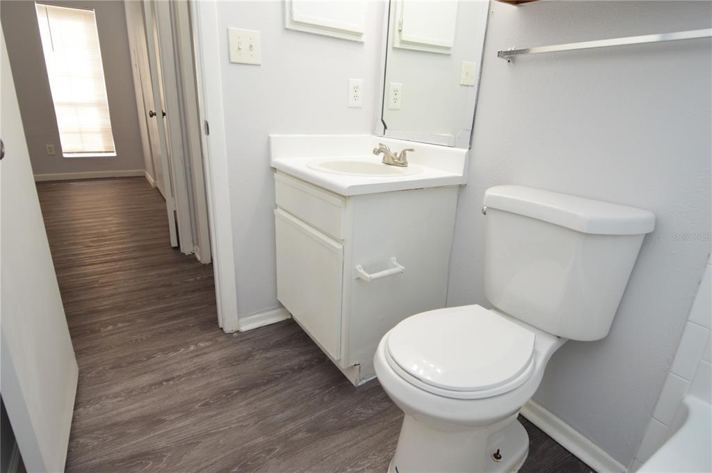 8641 Fancy Finch Drive, Unit 103 Tampa, FL 33614 - Photo 25 of 92 a bathroom with a toilet sink and mirror