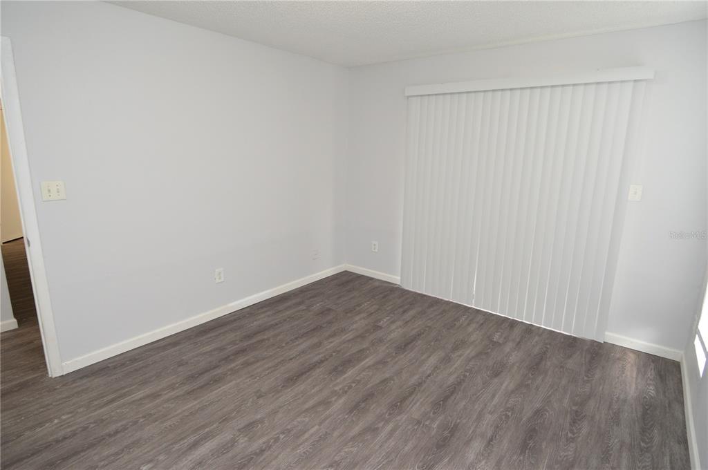 8641 Fancy Finch Drive, Unit 103 Tampa, FL 33614 - Photo 28 of 92 a view of an empty room with wooden floor