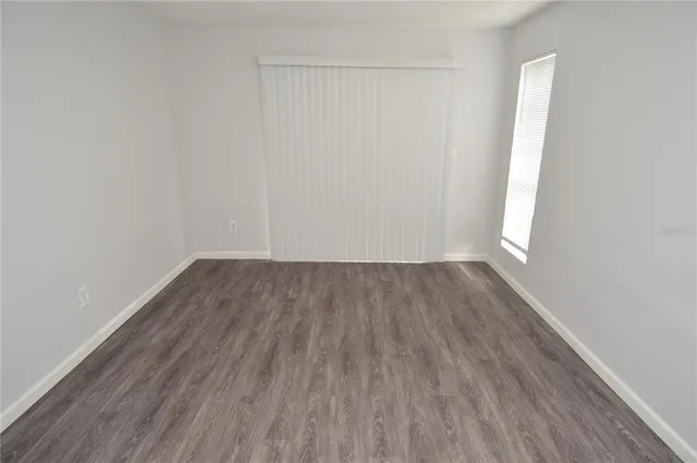 a view of a patio with table and chairs potted plants and large tree