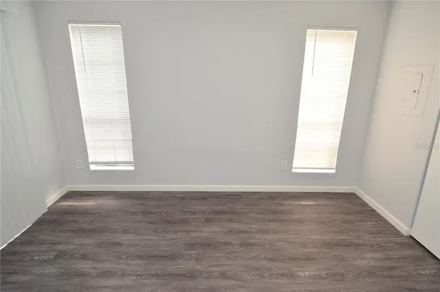 a view of a dining room with furniture large windows and wooden chandelier