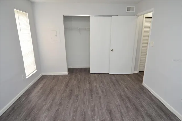 a view of a bedroom with furniture and washer