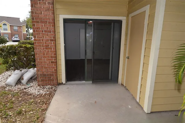 a view of a house with backyard porch and sitting area