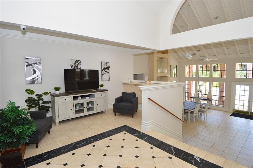 8641 Fancy Finch Drive, Unit 103 Tampa, FL 33614 - Photo 60 of 92 a living room with furniture and a flat screen tv